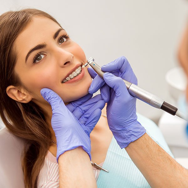 Dentist treating patient in local clinic